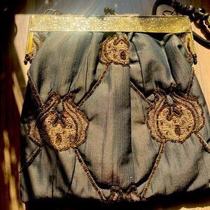 Lovely beaded evening bag with ornate metal closure and metal strap with beads